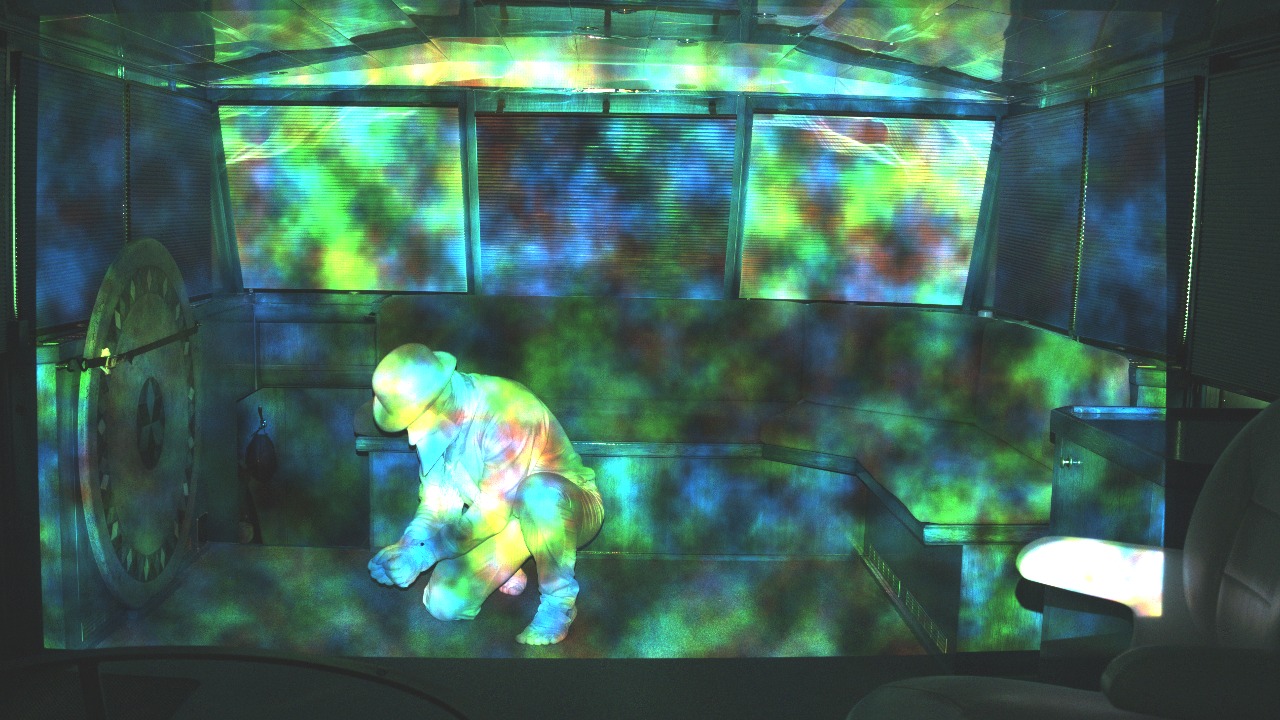 A real capture: a performer inside the loop, lit only by the projected challenge pattern